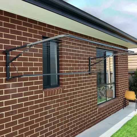 Brick wall with a window and metal bracket